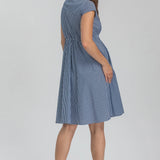 Woman wearing a blue striped dress on a white background