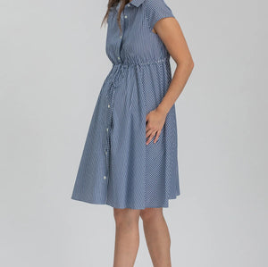 Woman wearing a blue striped dress on a gray background