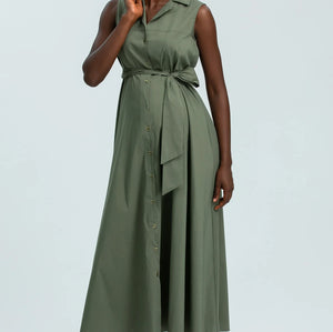 Woman wearing a green dress against a light gray background