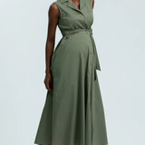 Woman wearing a green dress against a light gray background