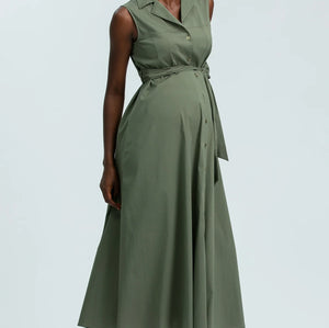Woman wearing a green dress against a light gray background