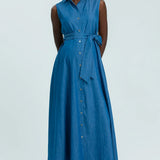 Woman wearing a blue sleeveless dress on a light gray background