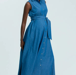 Woman wearing a blue sleeveless dress with buttons on a white background