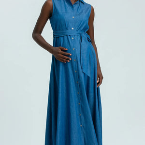 Woman wearing a blue sleeveless dress on a white background