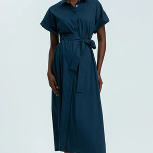 Person wearing a teal dress on a white background