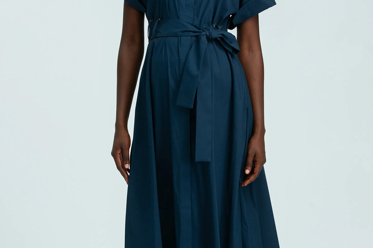 Woman wearing a blue dress on a white background