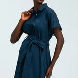 Woman wearing a blue dress against a white background