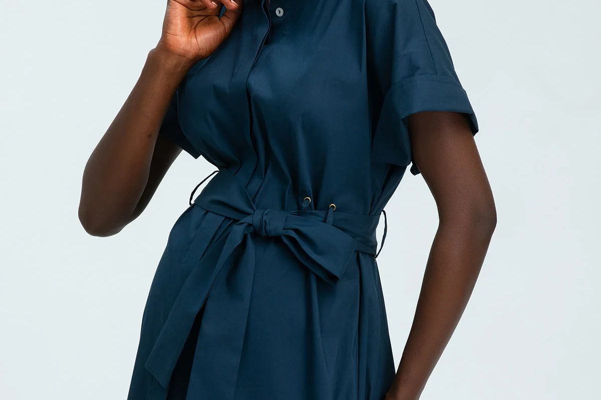 Woman wearing a blue dress against a white background