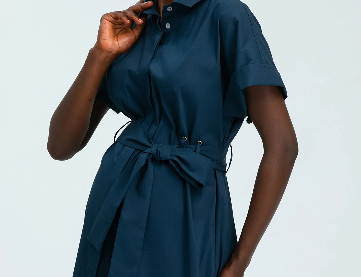 Woman wearing a blue dress against a white background