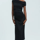 Woman wearing a black off-shoulder dress on a white background