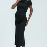 Woman wearing a black off-shoulder dress on a white background