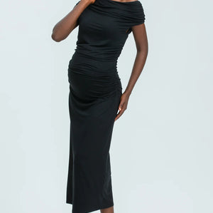 Woman wearing a black off-shoulder dress on a white background