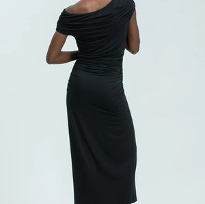 Woman wearing a black one-shoulder dress on a white background