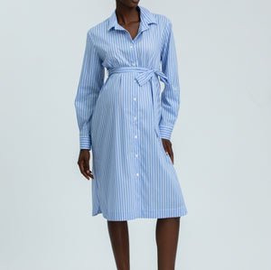 Woman wearing a blue and white striped dress on a white background