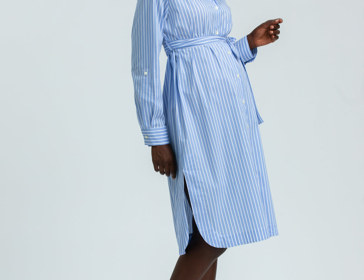 Woman wearing a blue striped dress on a white background