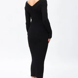 A woman modeling a black ribbed off-the-shoulder midi dress with long sleeves, shown from a side-back angle against a plain white studio background.