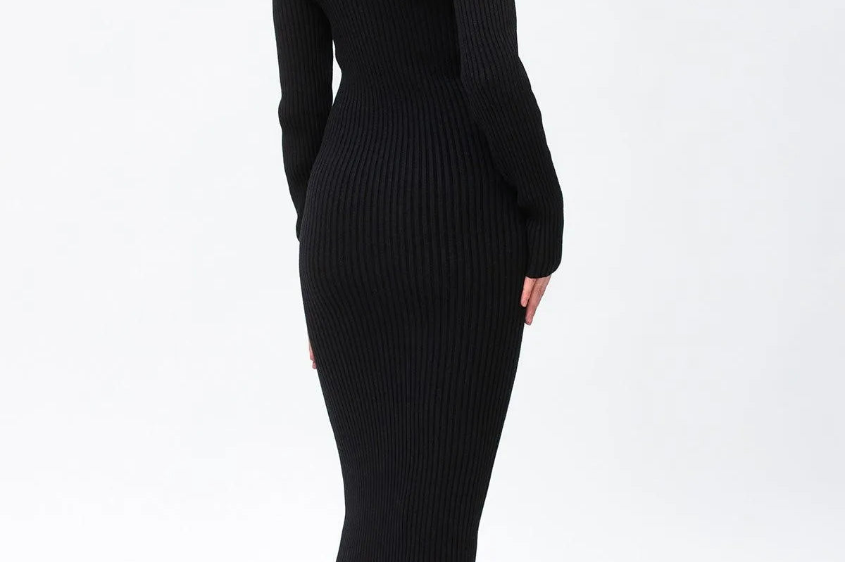 A woman modeling a black ribbed off-the-shoulder midi dress with long sleeves, shown from a side-back angle against a plain white studio background.