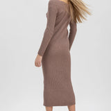 A woman modeling a ribbed knit long-sleeve midi dress in a muted taupe-brown color, paired with dark brown lace-up ankle boots, against a plain light gray studio background.