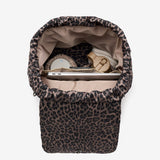 Leopard print baby bouncer with items inside on a white background