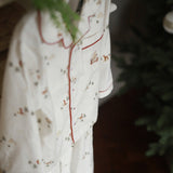 White fabric with embroidered designs on a dark background