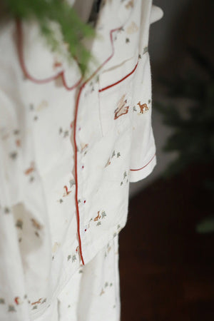 White fabric with embroidered designs on a dark background