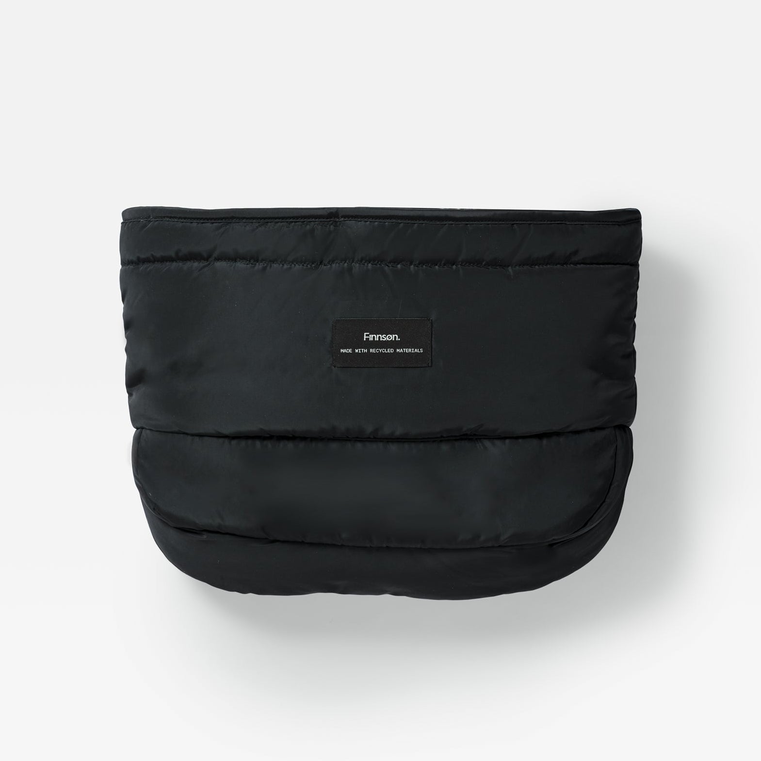 Agnar Eco stroller mitten in black, front view of the quilted outer with a small Finnson label on a plain background