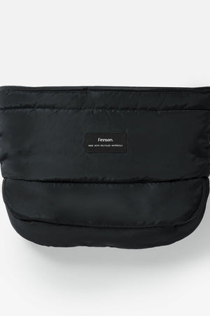 Agnar Eco stroller mitten in black, front view of the quilted outer with a small Finnson label on a plain background