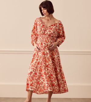 Albaray cream midi dress with orange botanical print, made from 100% organic cotton. Features a gathered tie neckline, ¾ sleeves, elasticated waist, and lined skirt with pockets – ideal for everyday comfort and effortless style.
