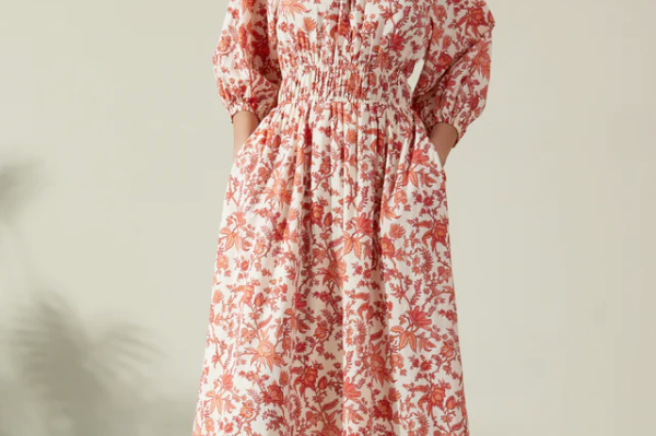 Albaray cream midi dress with orange botanical print, made from 100% organic cotton. Features a gathered tie neckline, ¾ sleeves, elasticated waist, and lined skirt with pockets – ideal for everyday comfort and effortless style.