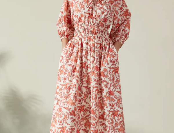 Albaray cream midi dress with orange botanical print, made from 100% organic cotton. Features a gathered tie neckline, ¾ sleeves, elasticated waist, and lined skirt with pockets – ideal for everyday comfort and effortless style.