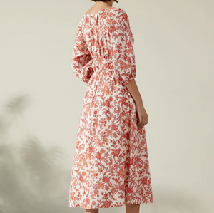 Albaray cream midi dress with orange botanical print, made from 100% organic cotton. Features a gathered tie neckline, ¾ sleeves, elasticated waist, and lined skirt with pockets – ideal for everyday comfort and effortless style.