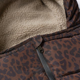 Close-up of a brown and black leopard-print puffer jacket with a beige sherpa fleece lining and a black zipper.