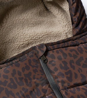 Close-up of a brown and black leopard-print puffer jacket with a beige sherpa fleece lining and a black zipper.