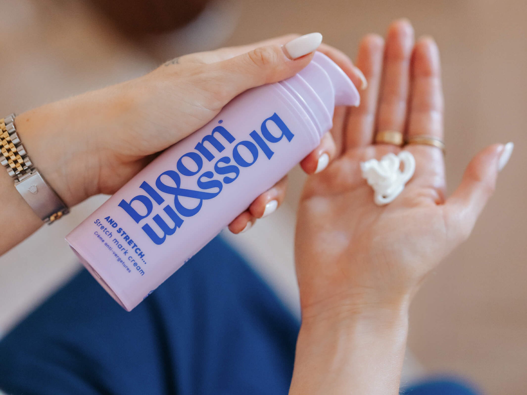 Person holding a 'bloom & bloom' product with visible branding.