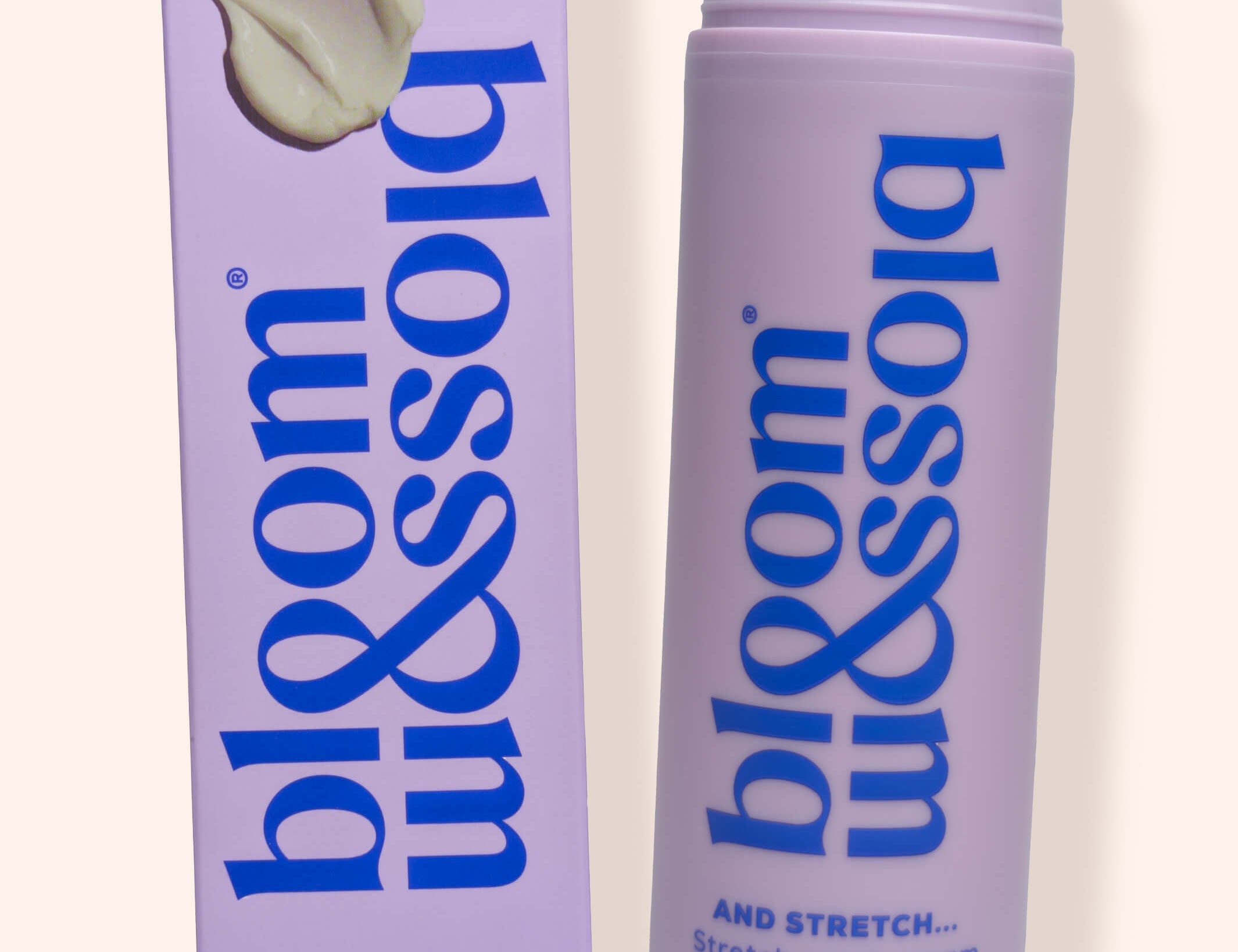 Bloss & Soak Stretch Mark Cream in a lavender pump bottle next to its matching lavender box packaging, set against a solid cream background.