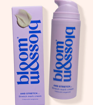 Bloss & Soak Stretch Mark Cream in a lavender pump bottle next to its matching lavender box packaging, set against a solid cream background.