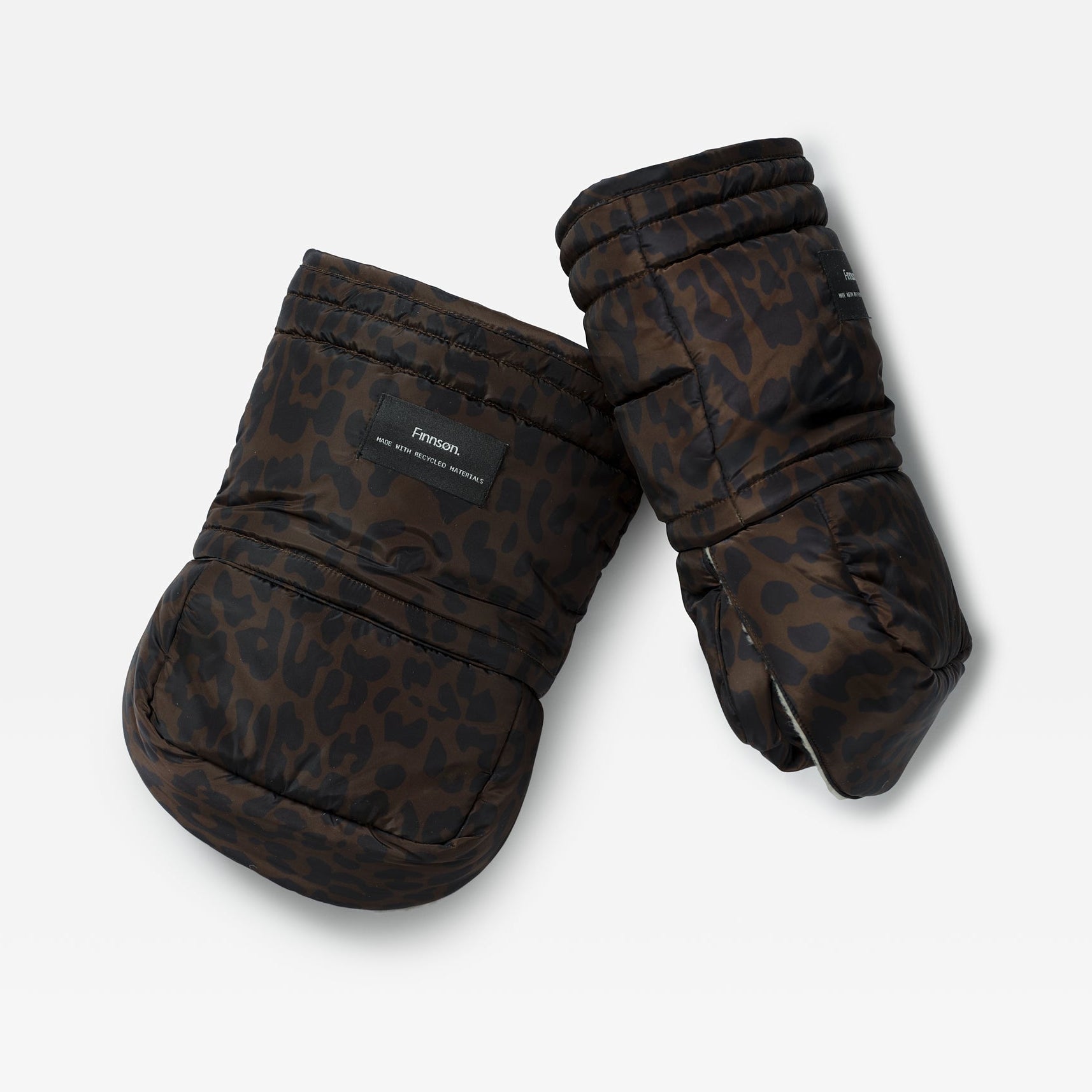 Pair of Astrid stroller mittens in Chocolate Leopard laid at an angle, showing the quilted cuff and hand opening