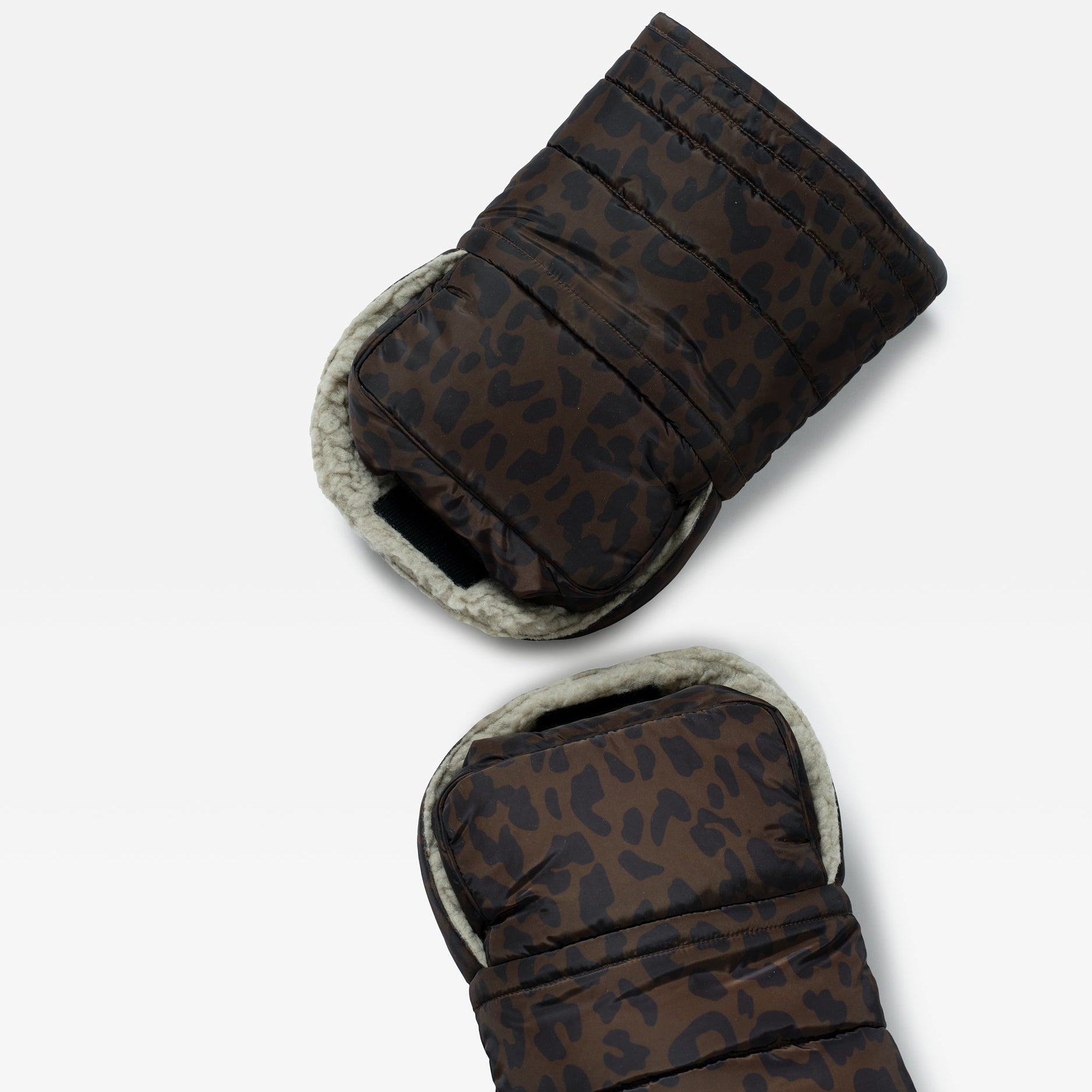 Inside of the Astrid stroller mittens in Chocolate Leopard, showing the cream fleece lining and hand strap