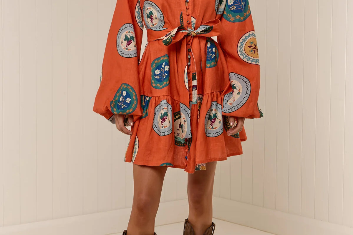 Model wearing Austin Mini Dress in Orange Plates print by Palm Noosa 