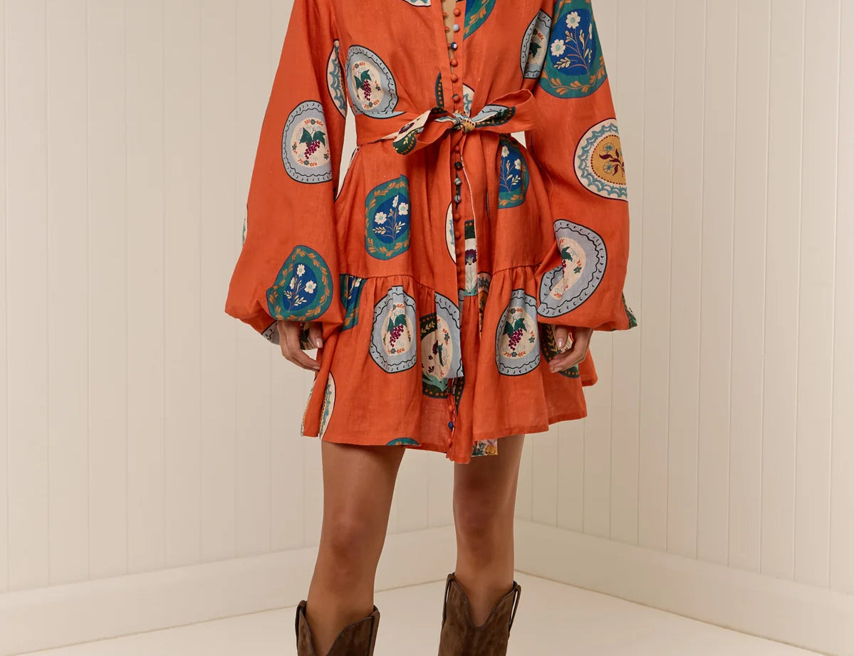 Model wearing Austin Mini Dress in Orange Plates print by Palm Noosa 