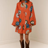 Model wearing Austin Mini Dress in Orange Plates print by Palm Noosa 
