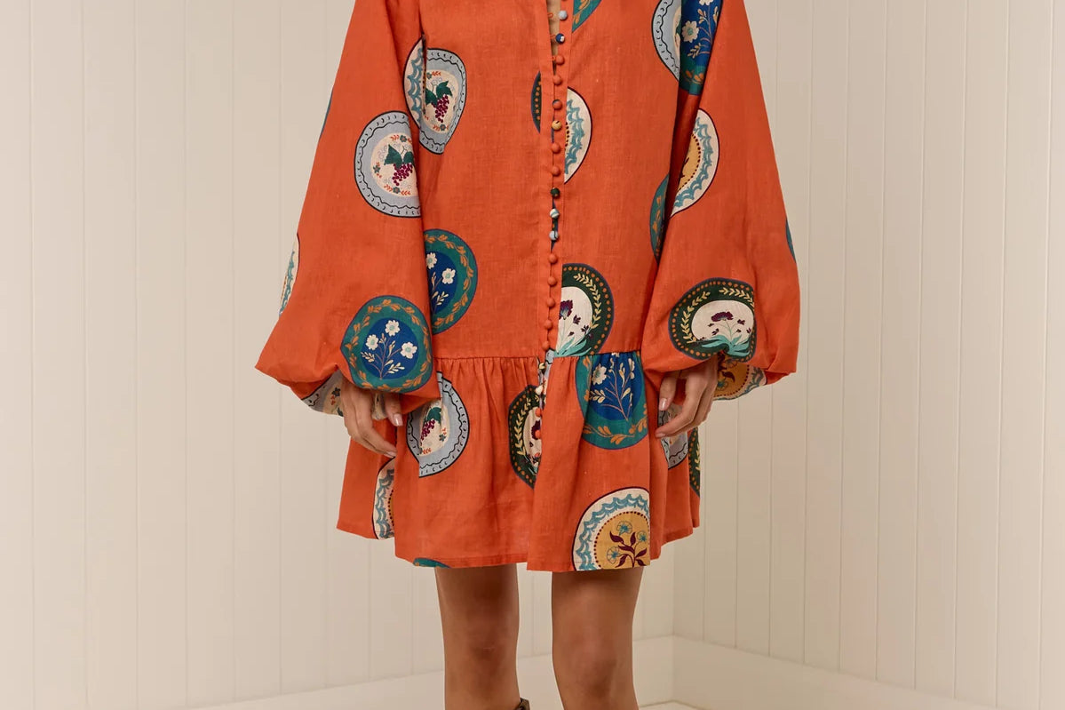 Model wearing Austin Mini Dress in Orange Plates print by Palm Noosa 