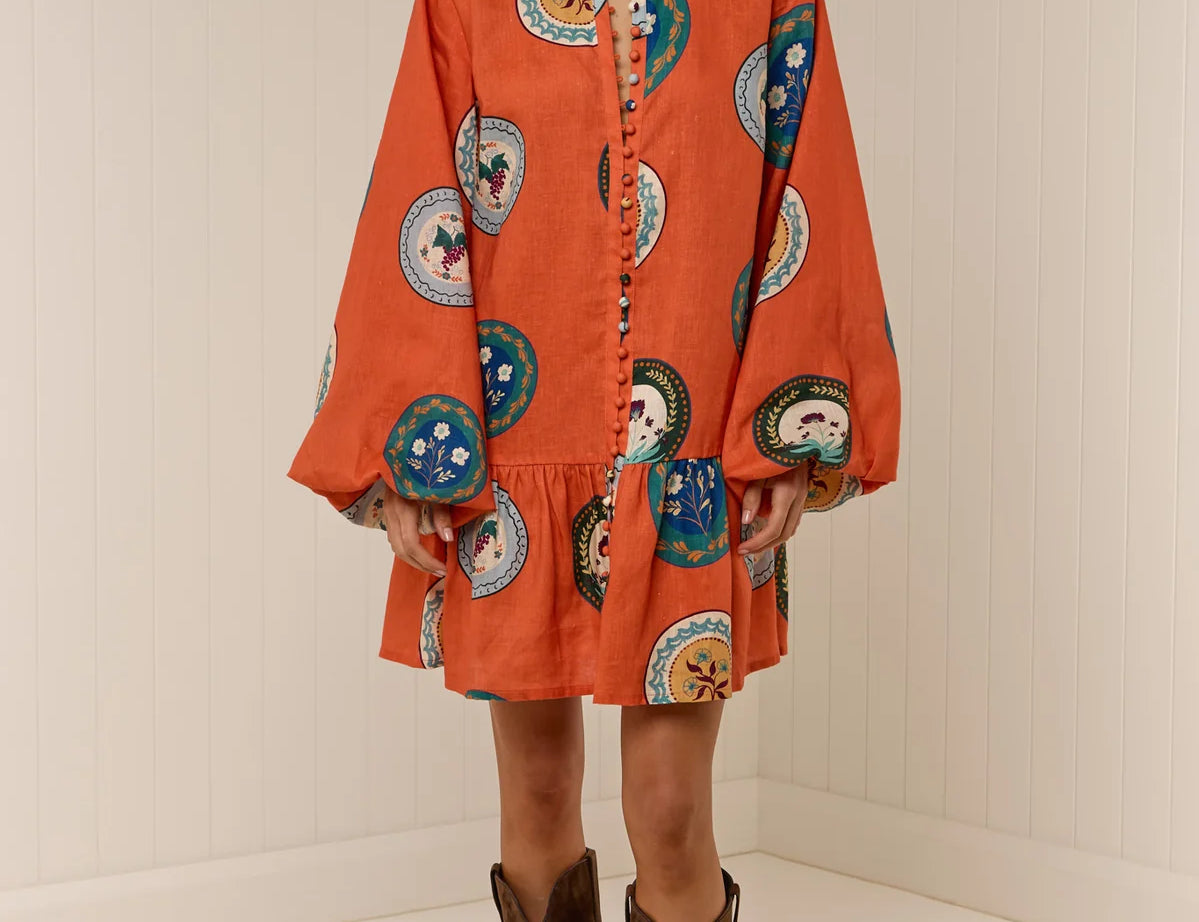 Model wearing Austin Mini Dress in Orange Plates print by Palm Noosa 