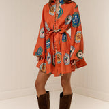 Model wearing Austin Mini Dress in Orange Plates print by Palm Noosa 