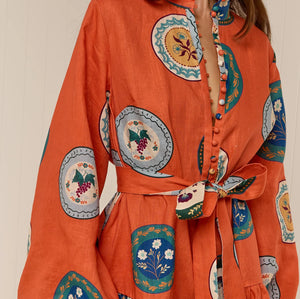 Model wearing Austin Mini Dress in Orange Plates print by Palm Noosa 