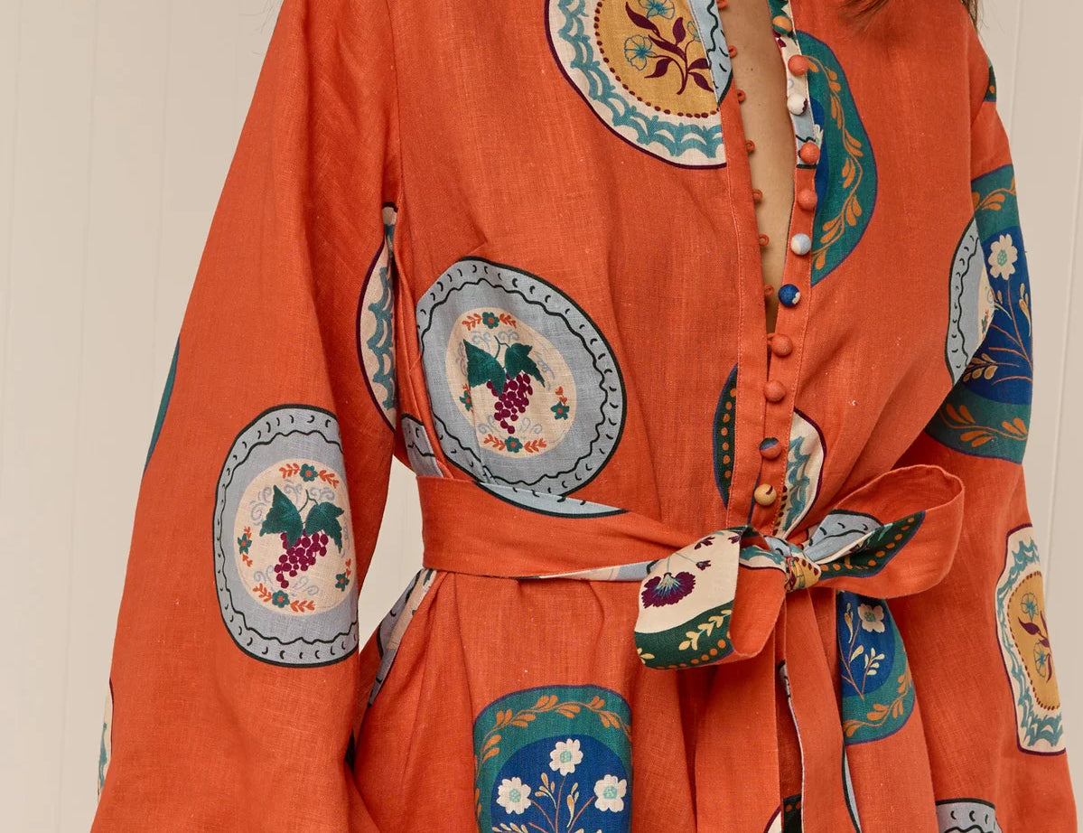 Model wearing Austin Mini Dress in Orange Plates print by Palm Noosa 