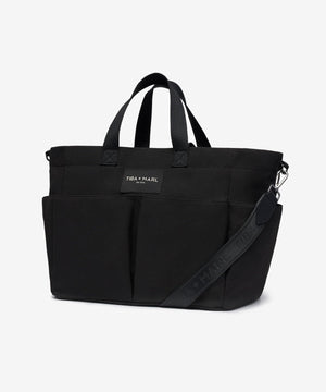 Black tote bag with a visible brand label on a white background