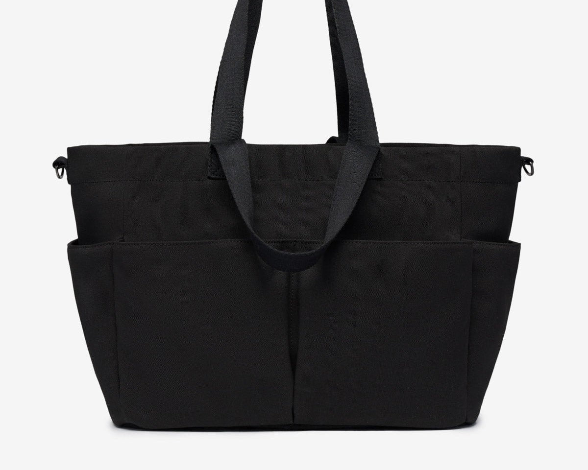 Black tote bag with multiple compartments on a white background