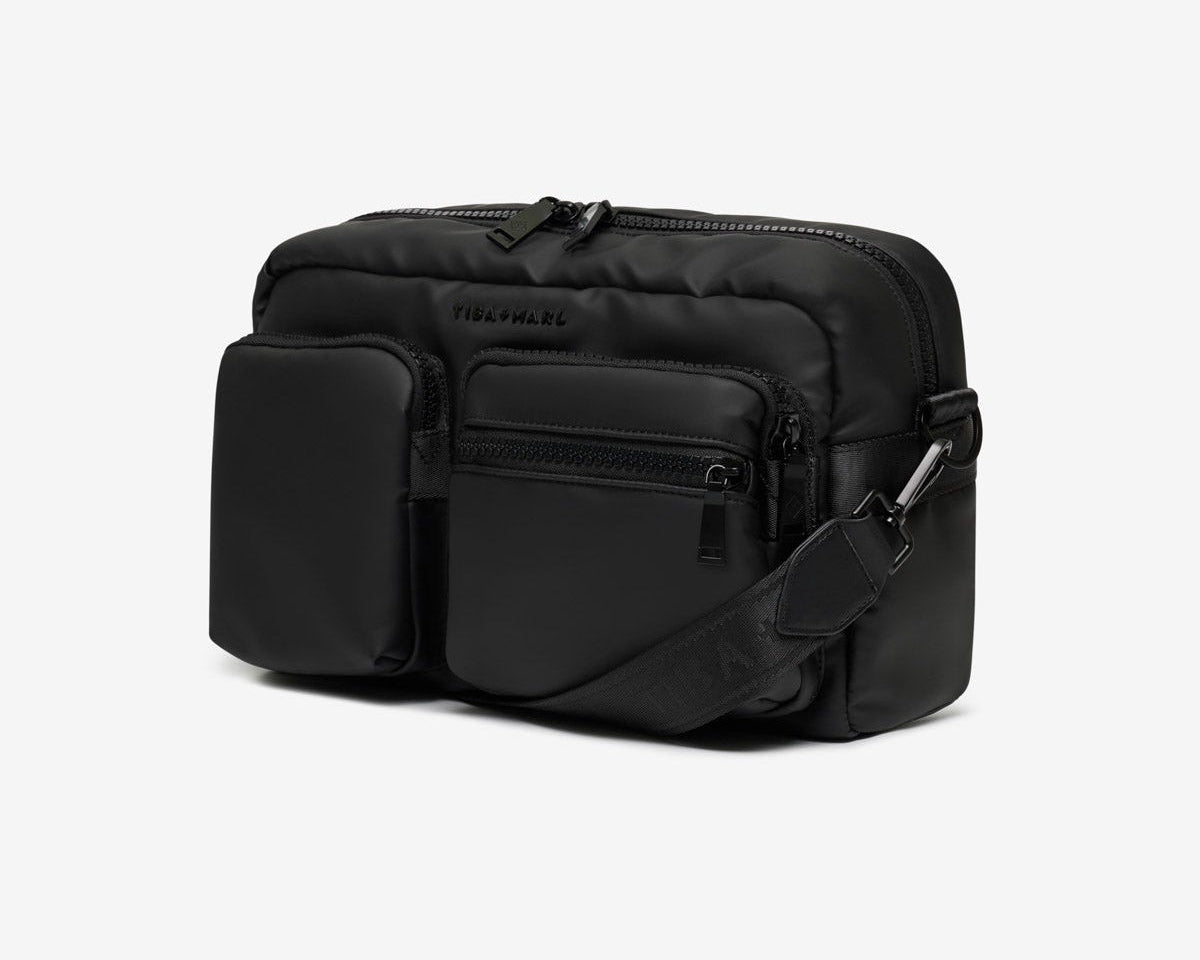 Black crossbody bag on a light gray background