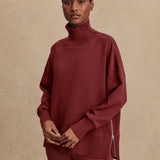 Model wearing Varley Barker high-neck oversized sweatshirt in soft DoubleSoft® fabric.
